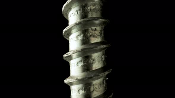 Part of a Stainless Spiral Screw Thread on an Isolated Black Background alt