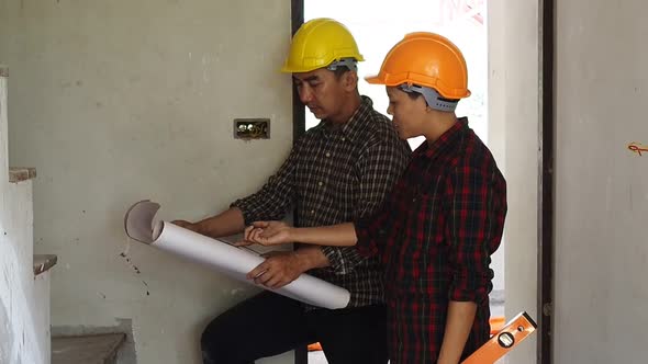 Architect discuss with engineer about project in office.