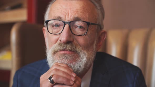 Elderly Businessman in Formal Suit with Whiskey and Cigar at Luxury Interior alt