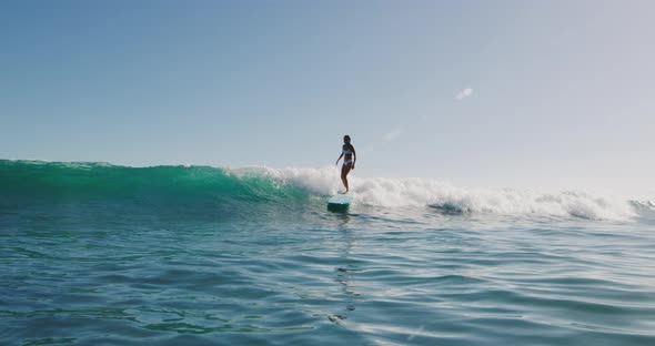Young happy woman surfing in the sun
