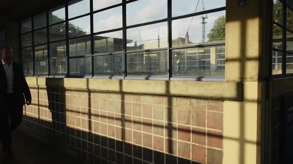 Business Man Walking to Work on Morning Commute in London underground tube train - Tripod Static alt
