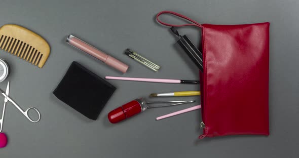Women's Cosmetics and Makeup Tools Fly Into an Open Cosmetic Bag