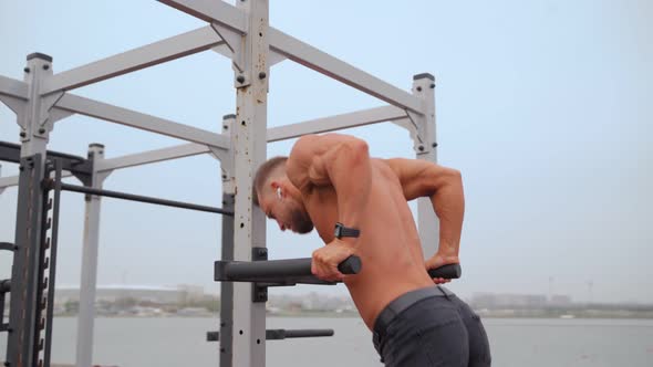 Athletic Man Pumps Up Muscles Doing PushUps Open Sports Ground with Naked Torso alt