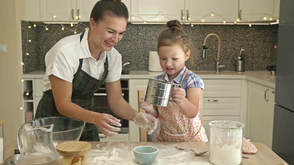 Little Daughter Helps Her Mother To Cook Some Dough, Fun and Rewarding Family Time alt
