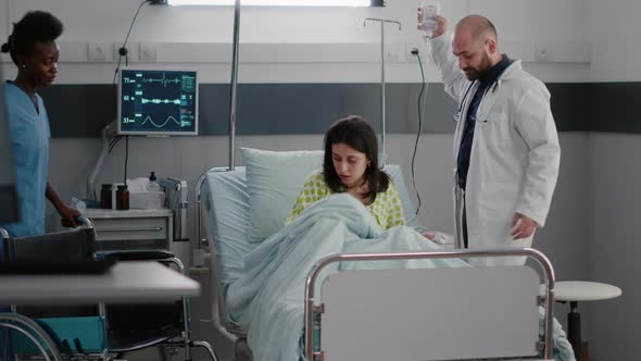 Therapist Doctor Analyzing Heart Pulse During Medical Consulting in Hospital Ward alt