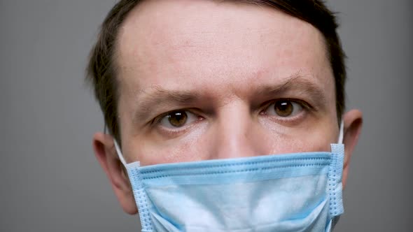 Unshaven Man Takes Off Protective Mask. Protective Measurements. Coronavirus Covid-19 Social alt