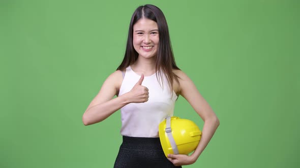 Young Beautiful Asian Businesswoman As Engineer Giving Thumbs Up