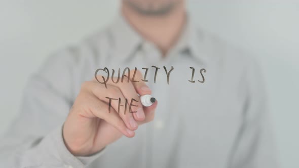 Quality Is The Key Writing on Screen with Hand alt