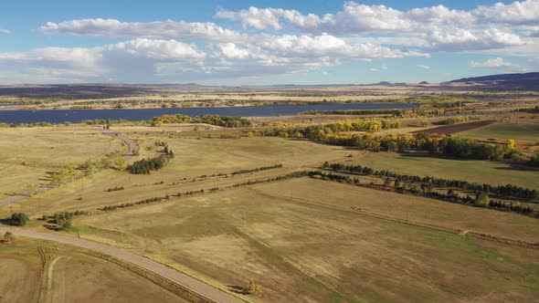 A pan along an open valley south of Denver.  Chatfield Reservoir is captured on the horizon alt