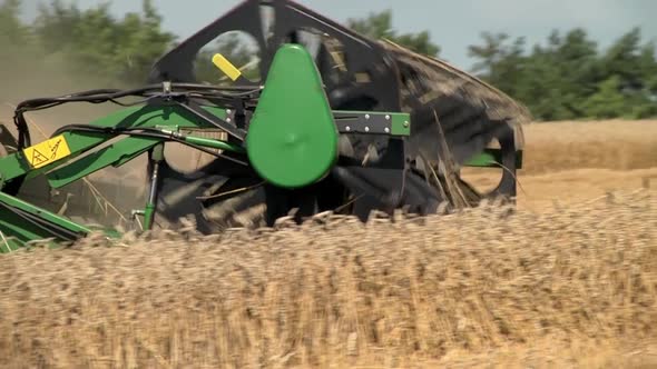 The Combine Harvester Mows Ears of Ripe Wheat