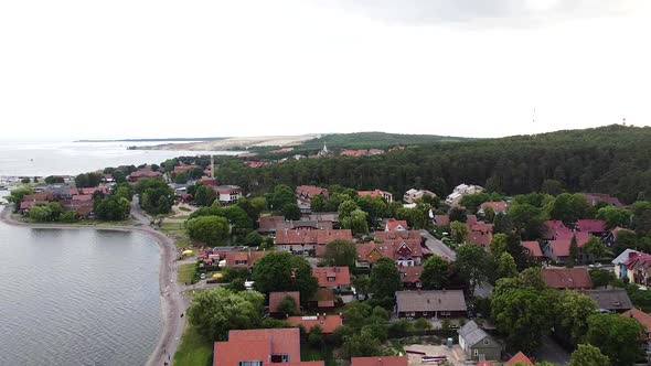 Lithuanian resort Nida town with magical red rooftops, aerial drone view alt