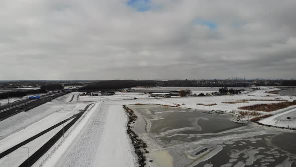 Snow and ice covering the ground at Crezepolder, Netherlands. Aerial wide shot. alt