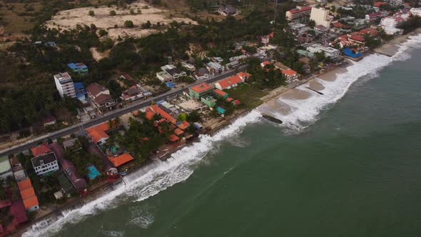 Ocean water almost hitting Vietnamese town. Beach erosion problem. Aerial drone view alt