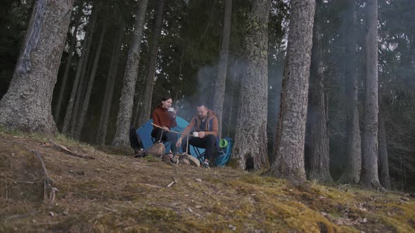 A Beautiful Cinematic Shot of Two Young Tourists a Man and a Woman in Wood alt