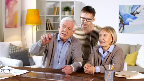 Grandparents and Grandson Using Invisible AR Display alt