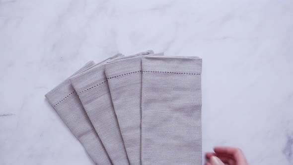 New linen dinner napkin on marble countertop. alt