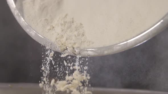 Flour is Poured From a Metal Bowl in Slow Motion