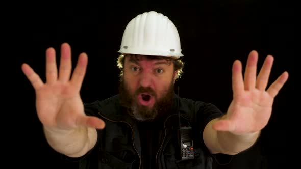 Concept idea: Bearded construction worker tries to stop someone with hand signals