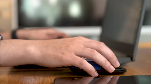 Man using mouse with laptop