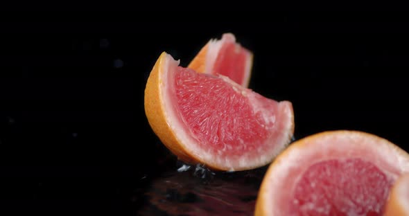 Grapefruit Pieces Fall on the Water Splashes.  alt