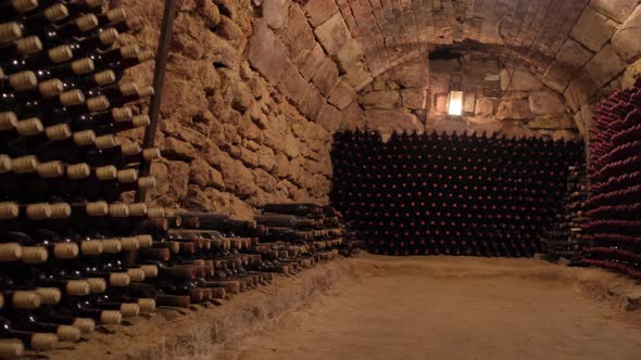 Old Wine Bottles in Rows in the Wine Cellar alt
