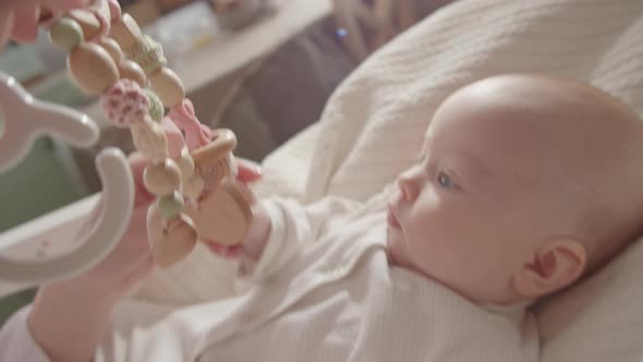Sweet Baby Looking at Crib Toys alt