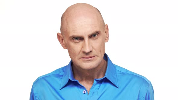 Middleaged Caucasian Male in Blue Shirt Standing at Gaze on White Background alt