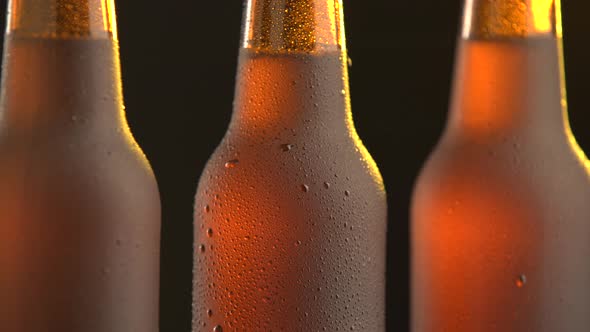 Three beer bottle rotating on black background