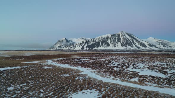 Iceland Aerial View Flying Fast Above Snow Covered Fields In Winter. 4K UHD video. alt