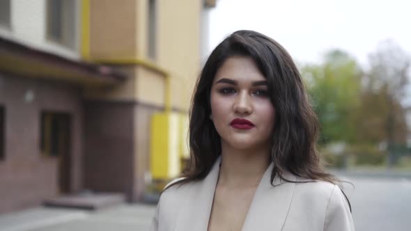 Seductive Look of a Passionate Brunette with Tempting Makeup Stands in Pose alt