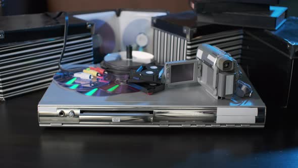 Man Inserting DVD Disc to Video Player alt