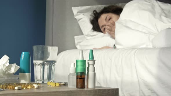 Sick Woman with Symptoms of Flu Cold or Coronavirus Lies in Bed