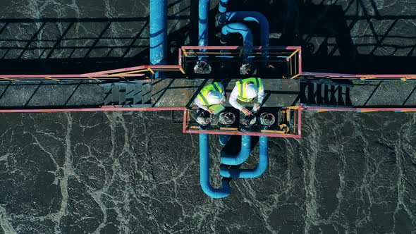 Top View of Two Workers Standing on the Sewage Cleaning Construction alt