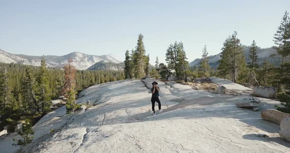 Drone Shot of Young Woman Taking a Photo with Professional Camera at Amazing Mountain Scenery in alt