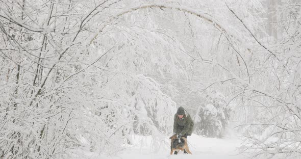 Young Active Caucasian Girl Woman Dressed In Jacket Playing Walking With Puppy Dog In Winter Forest alt