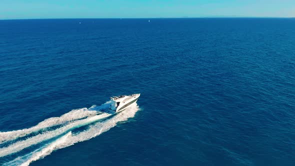 Aerial View. Boat Moves on the Sea. One Boat in the Blue Sea. Concept Travel and Vacation. alt
