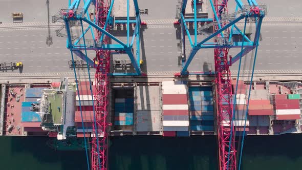 Drone Flying Over a Container Ship During Cargo Operations Over the Customs Area