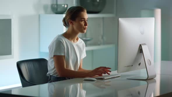 Confident Businesswoman Typing Desktop Computer alt