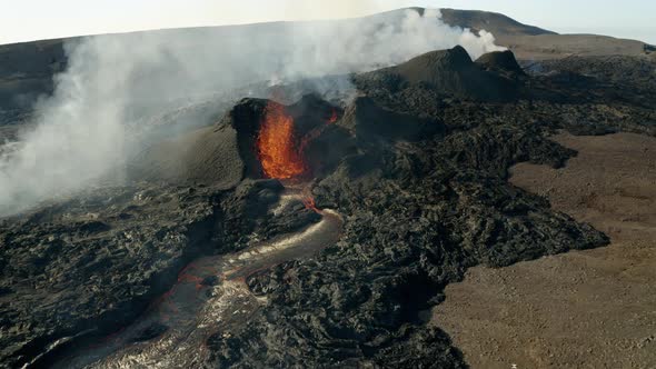 Epic aerial backwards shot of volcanic eruption with rising smoke during sunny day. Geldingadalir alt