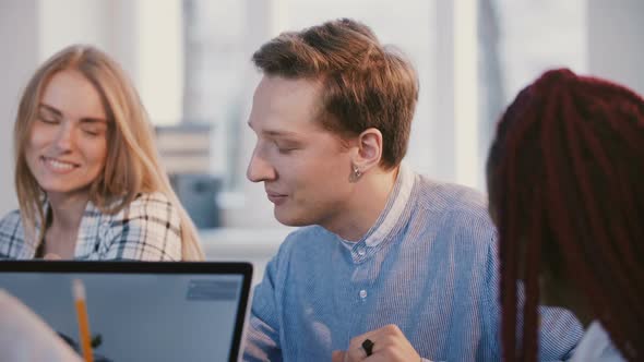 Medium Shot Portrait of Young Happy Successful Male Caucasian Office Worker Talking Behind Office alt