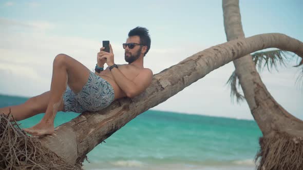 Traveler Looking At Cell Phone App And Browsing In Internet. Man Using Mobile Phone. Vacation. alt