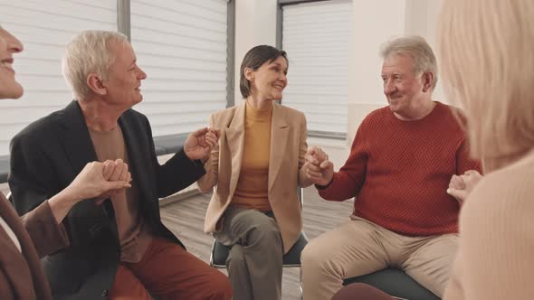 People Saying Affirmations and Holding Hands at Support Group Meeting alt