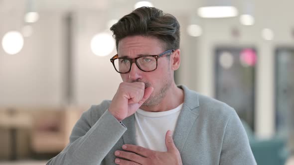 Portrait of Sick Middle Aged Man Coughing alt