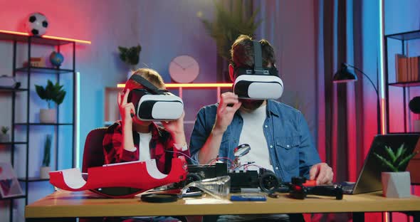 Father Finished to Repair Toy Car Together with His Nice Teen Son Using Screwdriwers alt