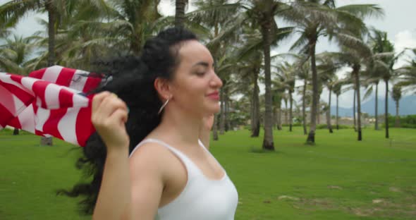 Patriotism Independence Day and Holidays Concept Happy Smiling Young Woman in Swimsuit with National alt