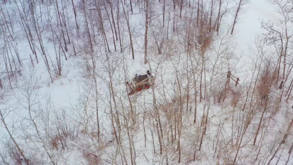 Clearing snow on a rural property with a wheeled bobcat alt