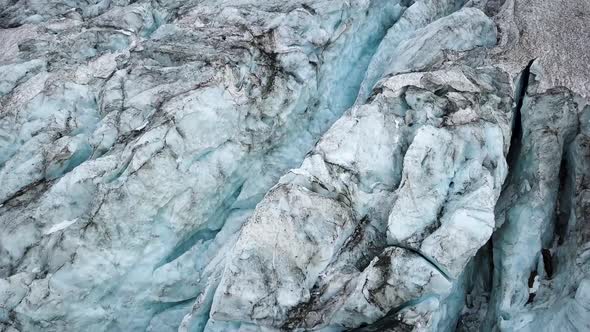 Aerial detail of a glacier crack seen topdown in the swiss alps in Europe alt