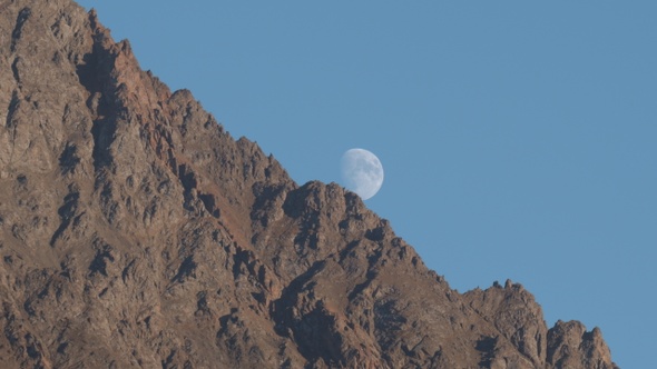 Rising of the Full Moon Before Sunset in the Mountains alt