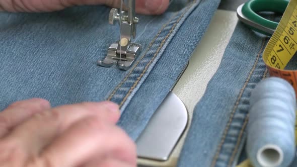 Seamstress is Working Sewing Clothes in Sewing Machine Hands Closeup alt