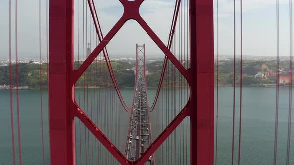 Slow Aerial Dolly in View of Dense Multi Lane Vehicle Traffic Across Red Ponte 25 De Abril Bridge in alt